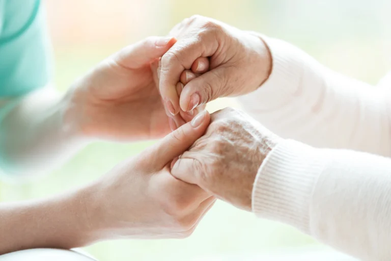 close up of two pairs of hands holding each other memory care facilities in Chicago
