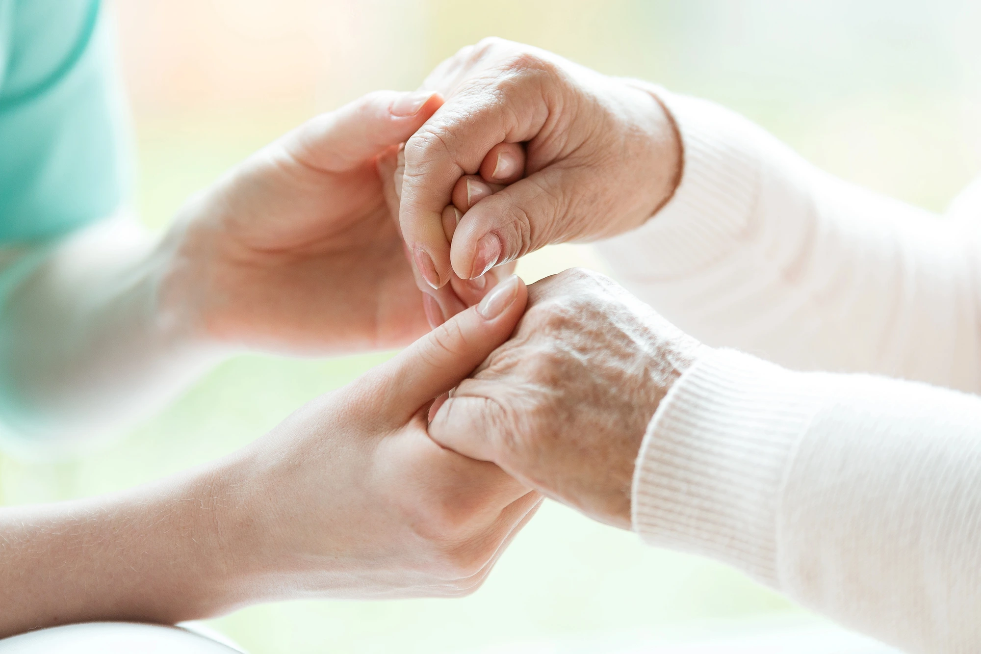 close up of two pairs of hands holding each other memory care facilities in Chicago