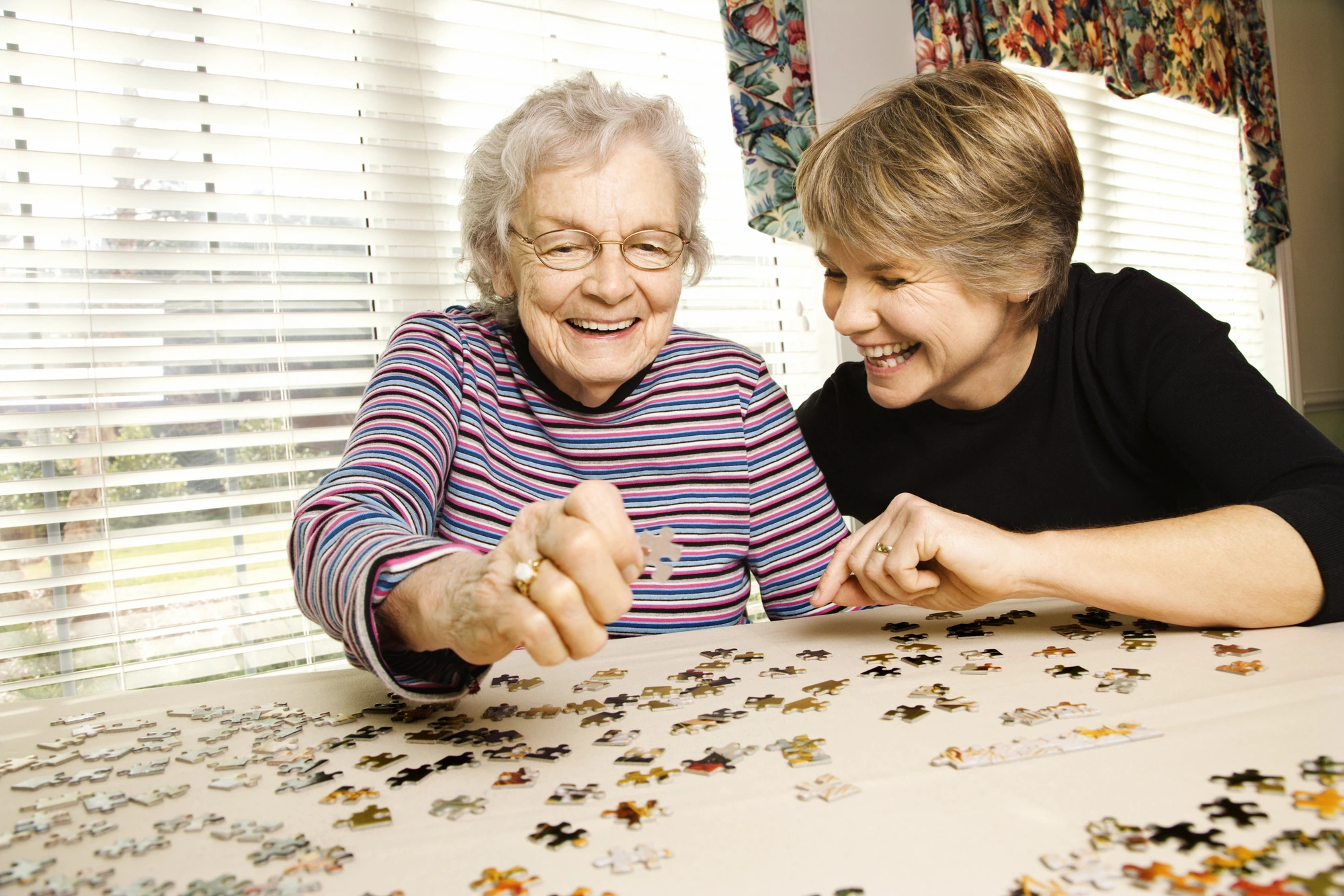 older ladies doing a puzzle at an assisted living in Lake Forest